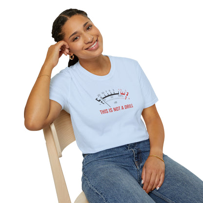 Smiling woman in casual t-shirt reading 'This Is Not A Drill' with audio meter graphic, seated