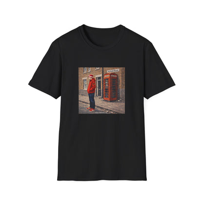 Black t-shirt with a printed design of a person in a red coat standing next to a red telephone box.