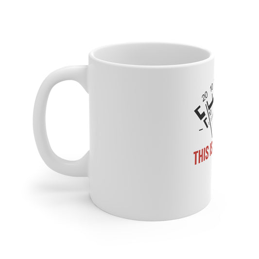 White ceramic coffee mug with eye chart design and red text partially visible on side