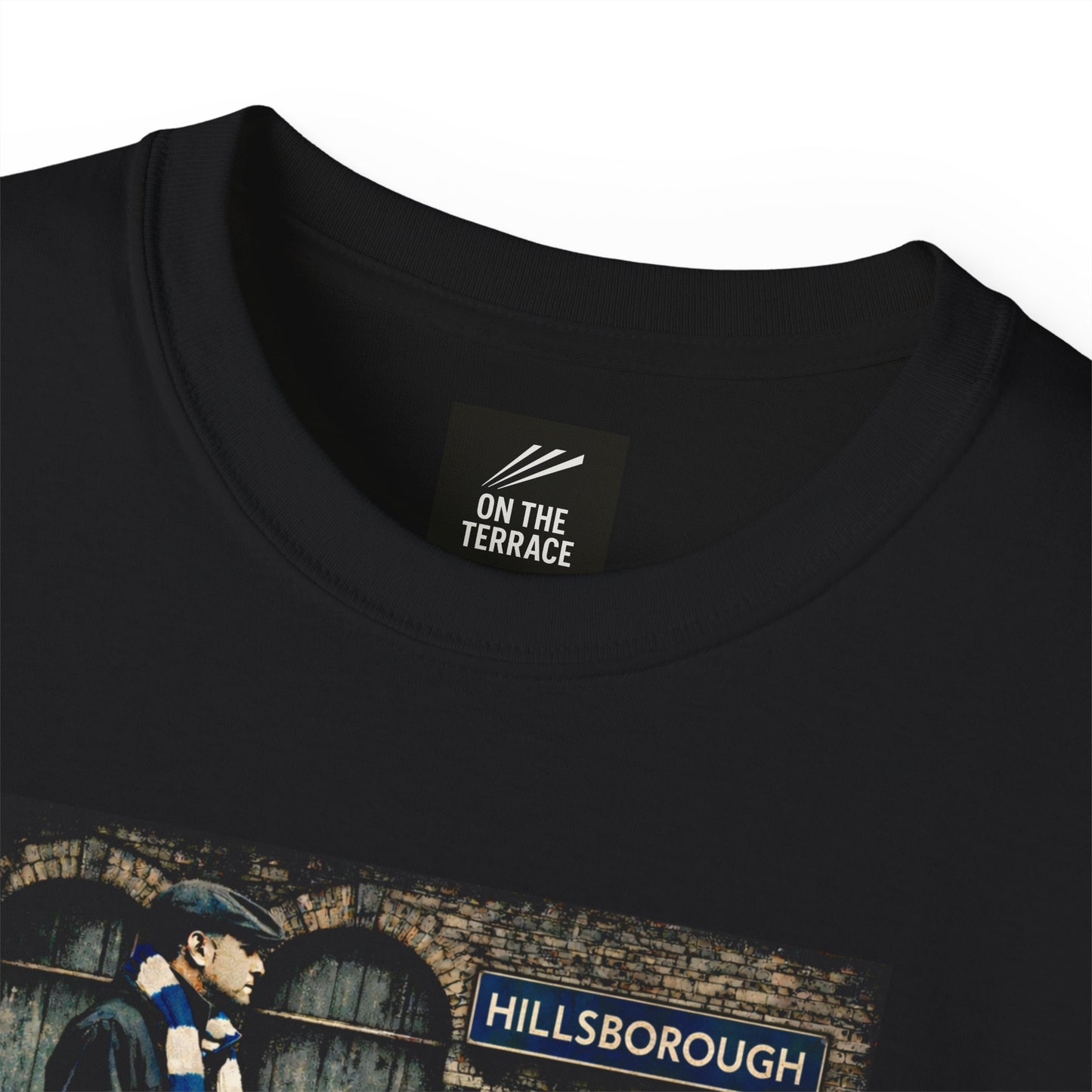 A close up image of the Black Sheffield Wednesday FC inspired t-shirt with vintage graphic of a fan in flat cap