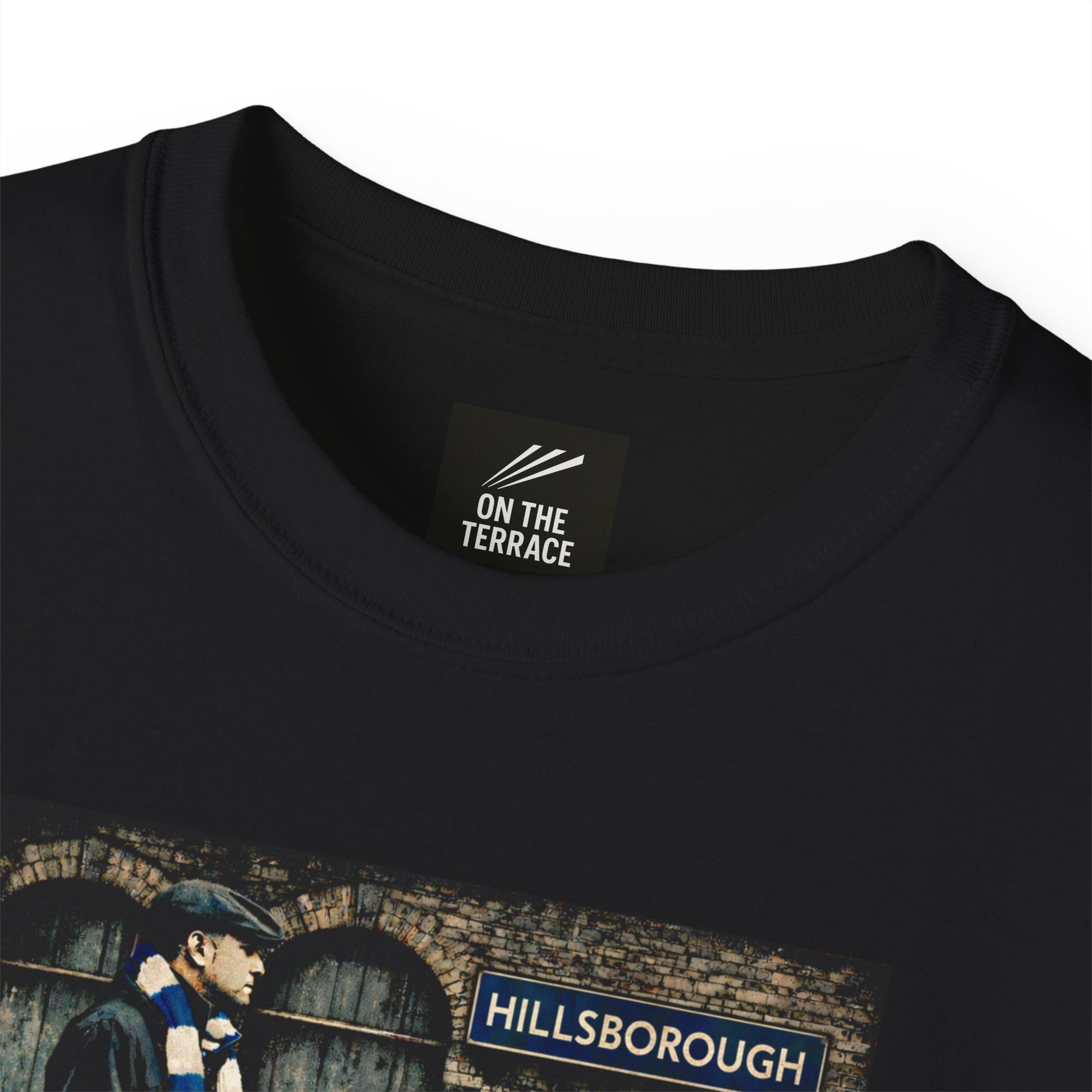 A close up image of the Black Sheffield Wednesday FC inspired t-shirt with vintage graphic of a fan in flat cap