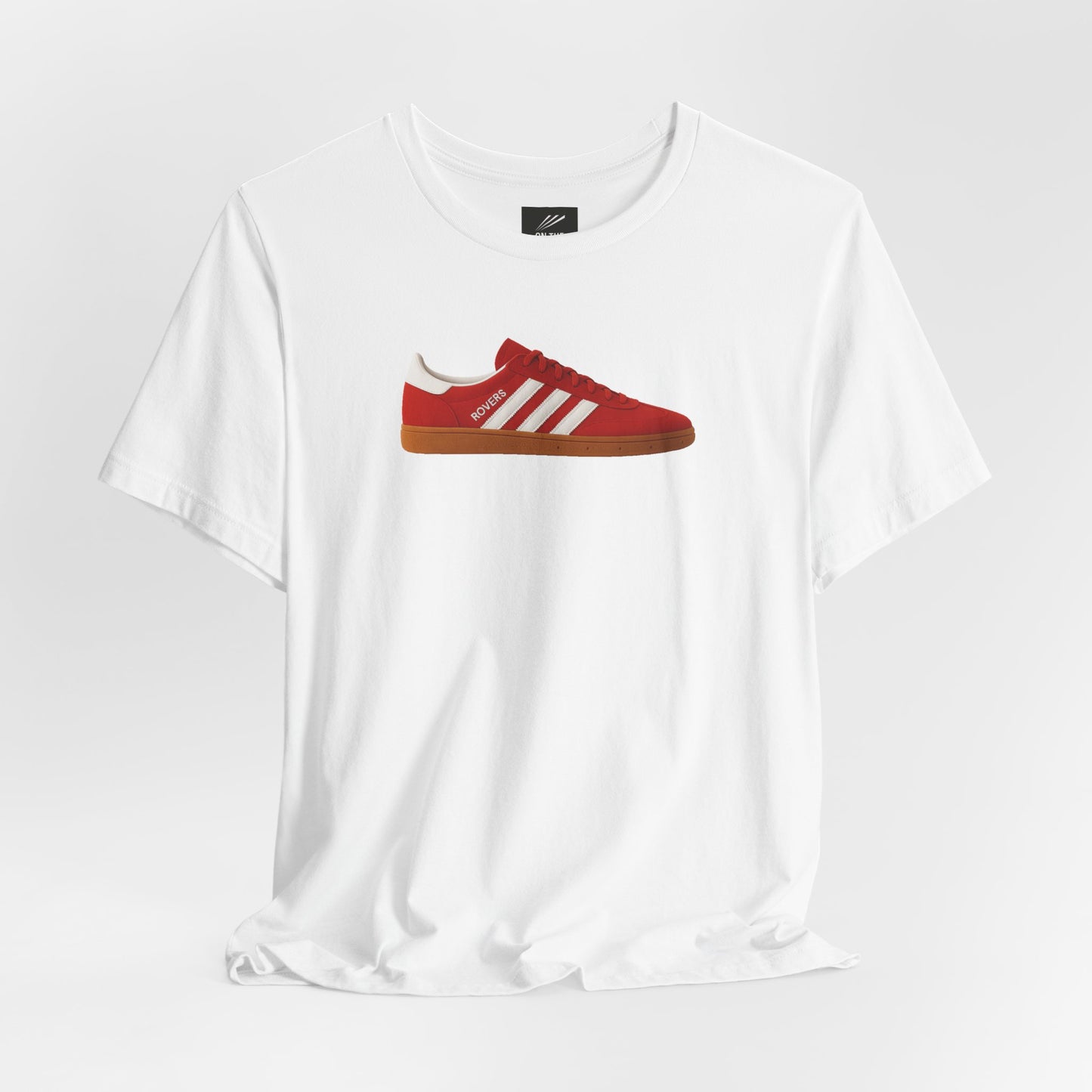 White T-shirt with a red sneaker graphic featuring white stripes and brown sole