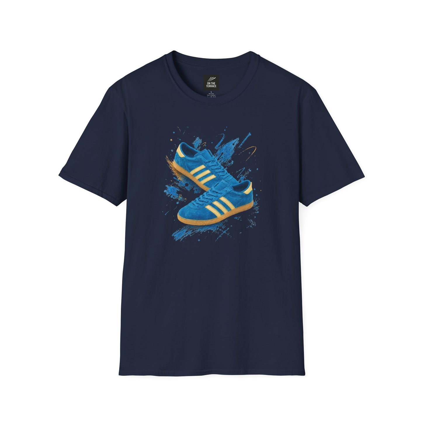 Navy blue t-shirt with a printed graphic of a blue suede trainer featuring cream stripes and a gum sole, surrounded by a blue and gold paint splatter design, with an "On The Terrace" logo on the neck label.