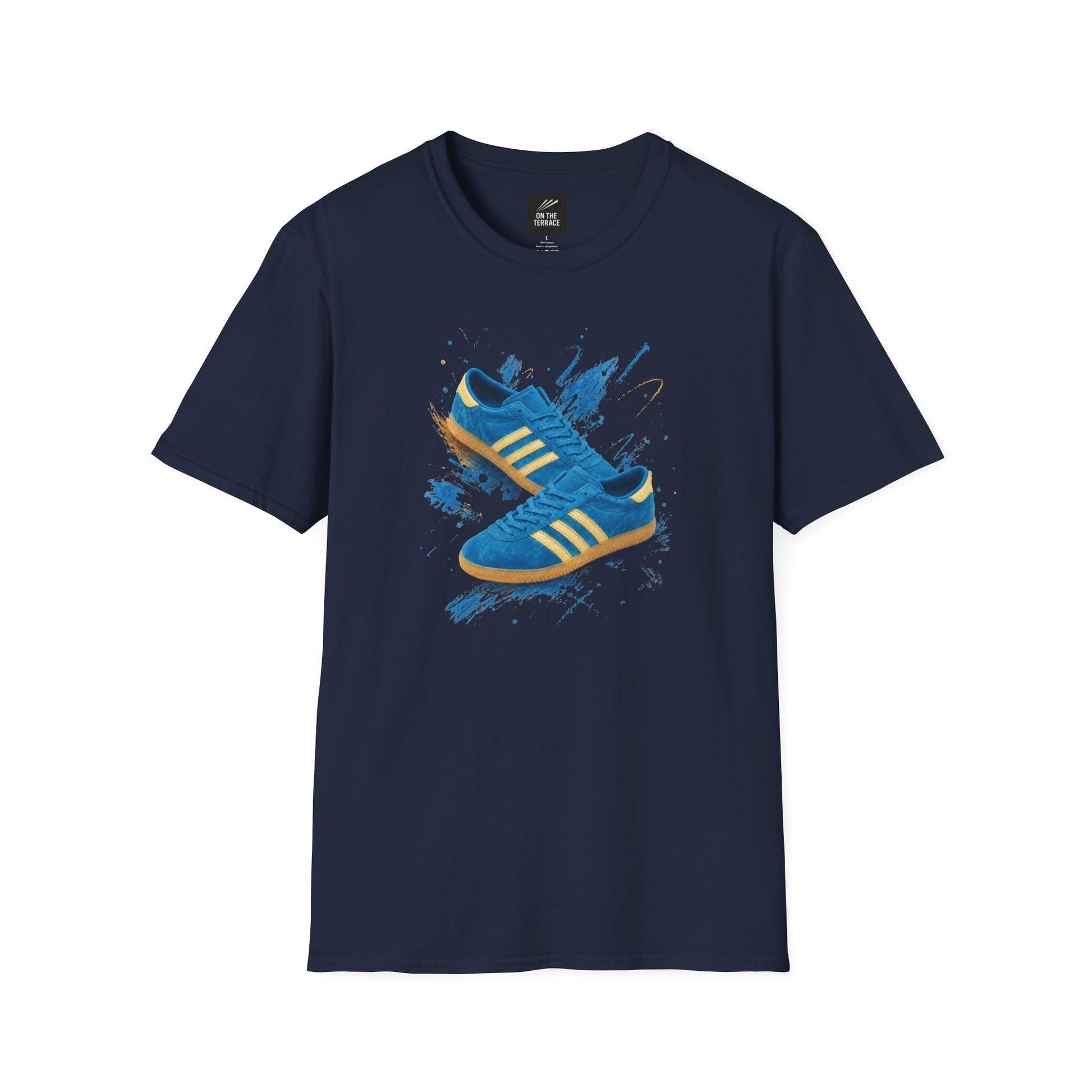 Navy blue t-shirt with a printed graphic of a blue suede trainer featuring cream stripes and a gum sole, surrounded by a blue and gold paint splatter design, with an "On The Terrace" logo on the neck label.
