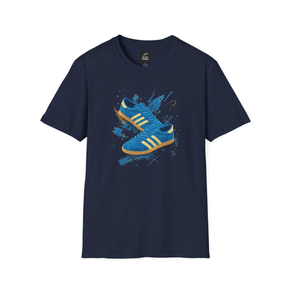 Navy blue t-shirt with a printed graphic of a blue suede trainer featuring cream stripes and a gum sole, surrounded by a blue and gold paint splatter design, with an "On The Terrace" logo on the neck label.