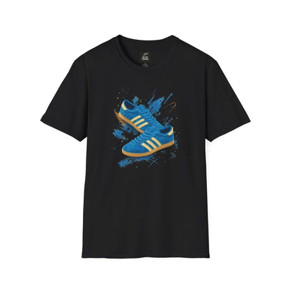 A black short-sleeve crewneck t-shirt featuring a graphic print of two blue Adidas sneakers with yellow stripes on a blue paint splatter background.