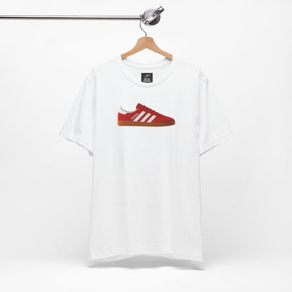 White t-shirt with graphic red sneaker and white stripes printed on front, hanging on wooden hanger