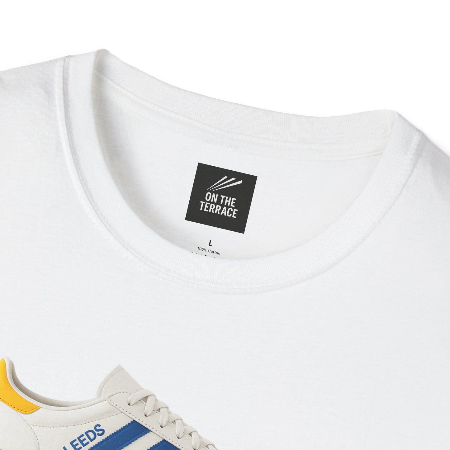 Close-up of white cotton T-shirt collar with 'ON THE TERRACE' label and partial view of white sneaker with blue stripes