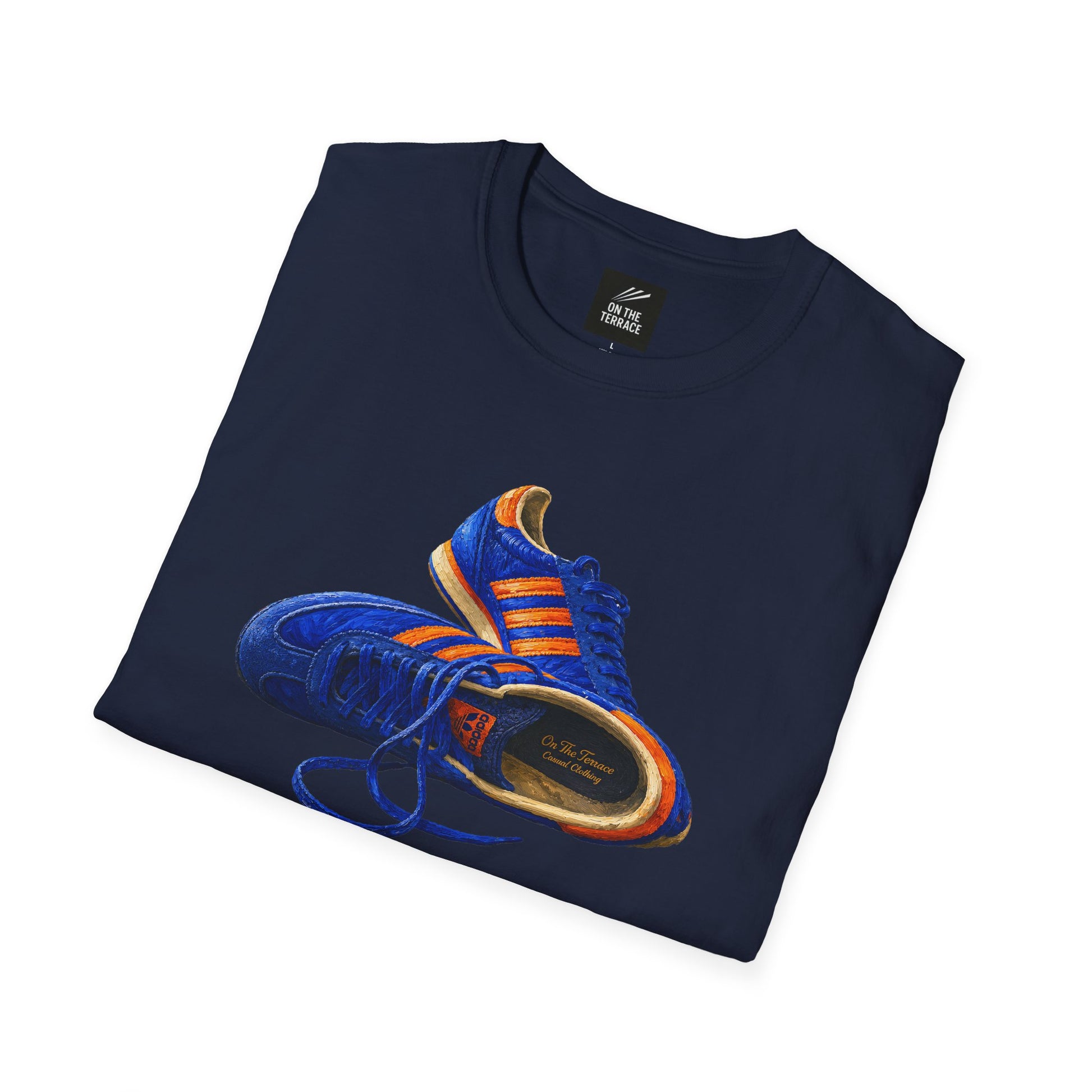 A navy folded Navy t-shirt with hand-illustrated blue and orange retro terrace trainer sneaker graphic print, On The Terrace casual clothing brand

