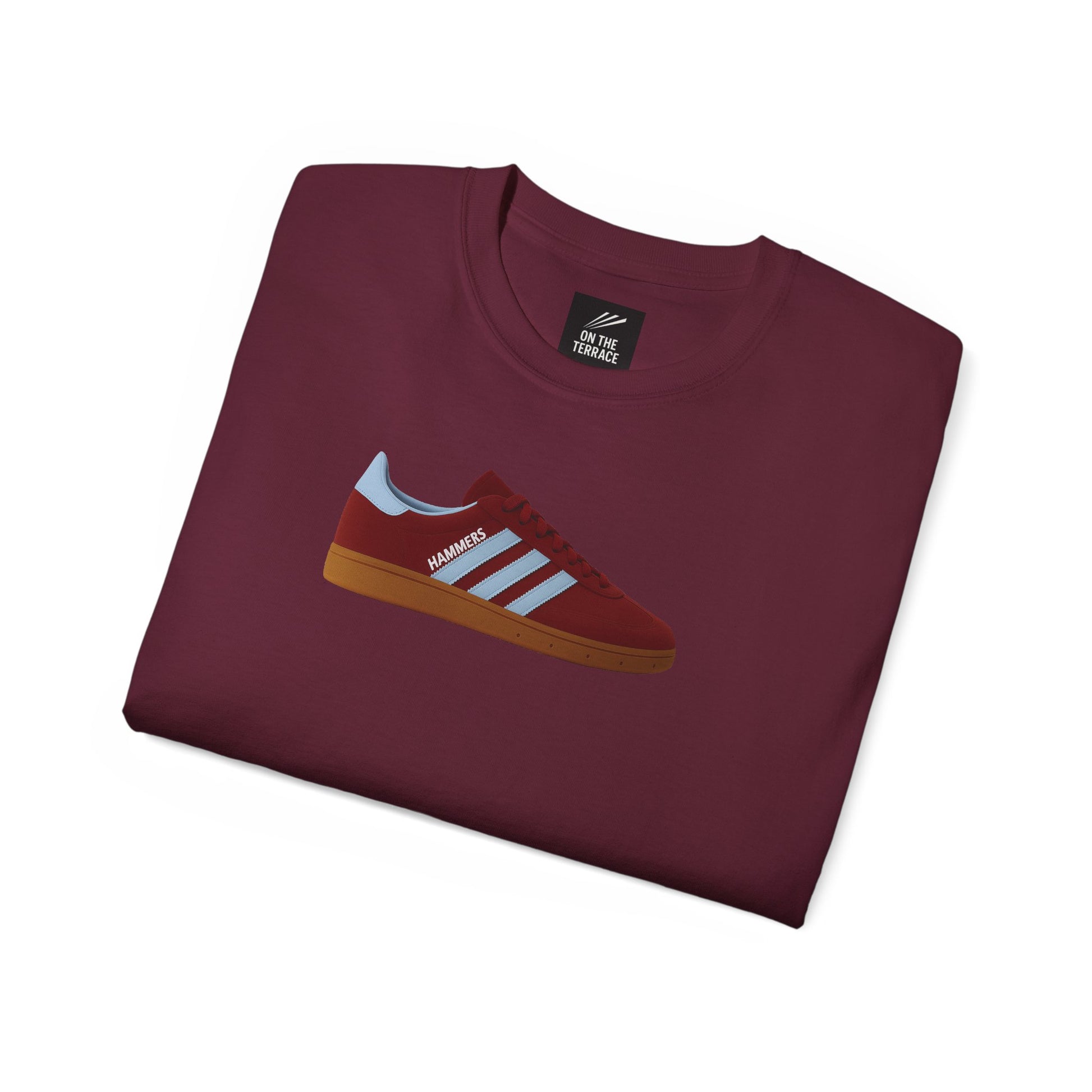 Folded maroon t-shirt with graphic of maroon and light blue sneaker labeled HAMMERS on white background