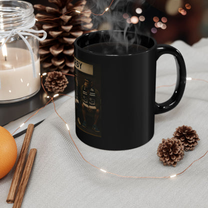 Black mug with text and graphics on a table with decorative items