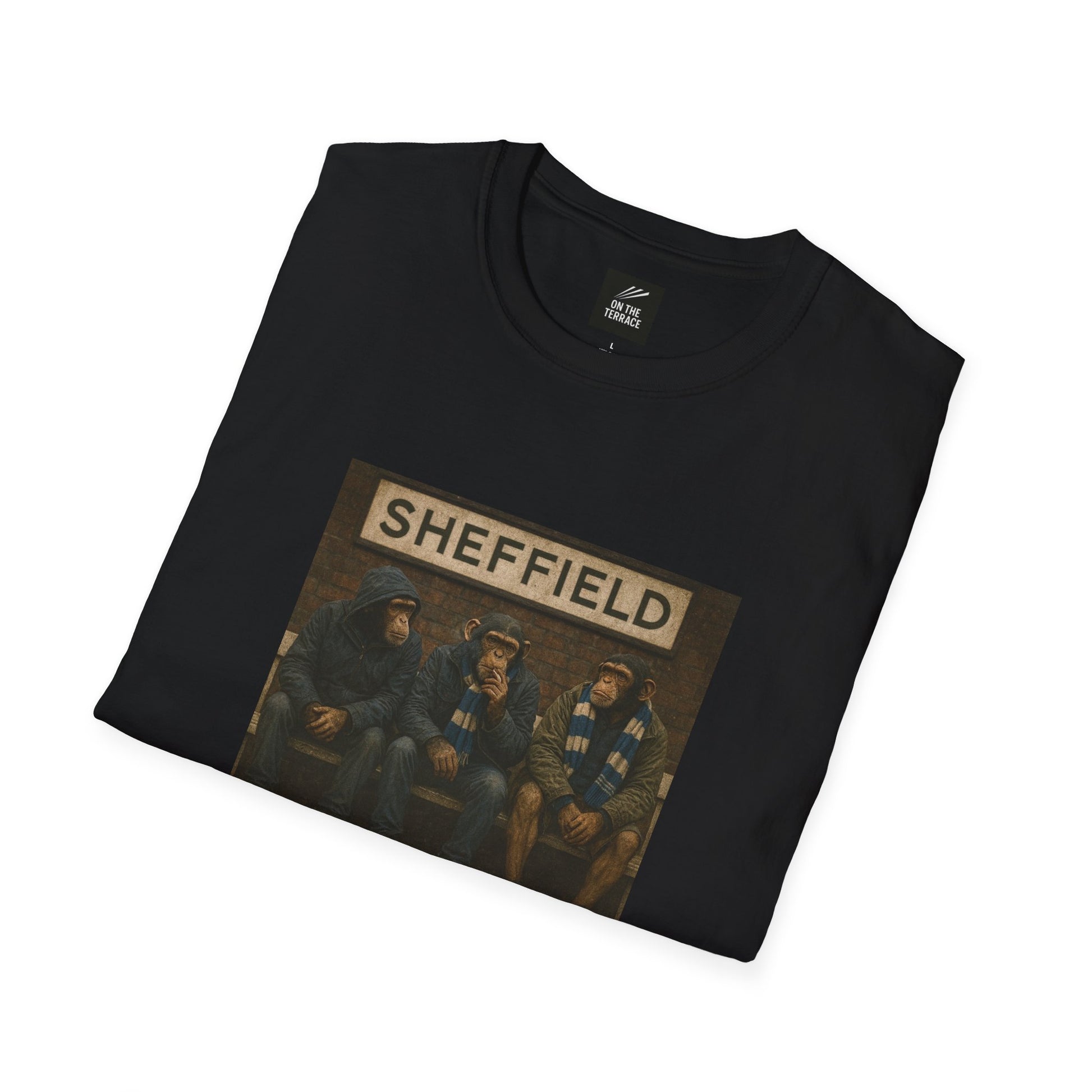 Folded Black t-shirt with a graphic of four people and 'Sheffield' text on a white background