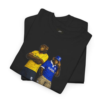 A folded black Birmingham t-shirt featuring a graphic print of two apes wearing sports jerseys, one in yellow with 'flybe' on the chest and one in blue with 'flybe' on the front, set against a plain white background.
