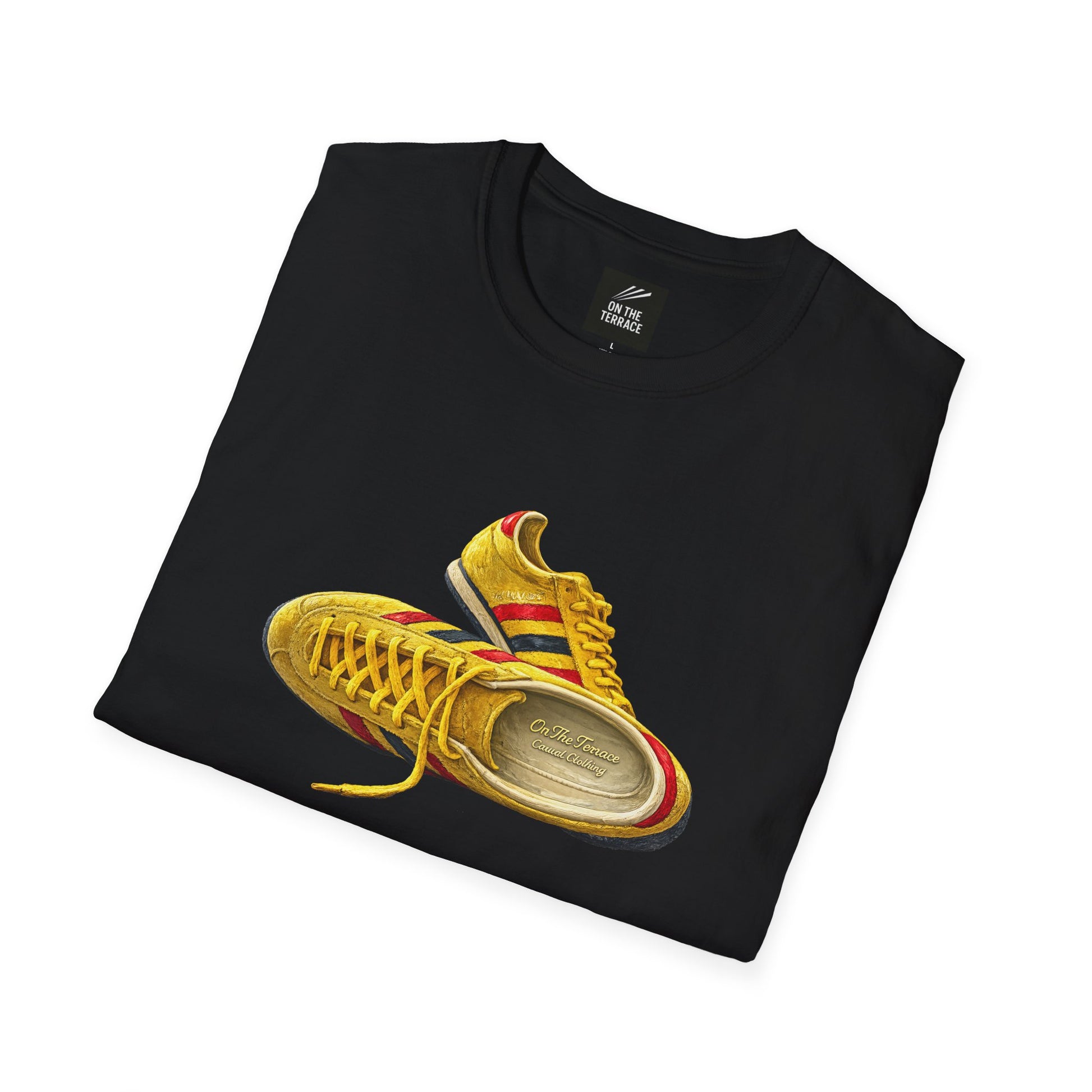 A black folded t-shirt featuring a graphic print of a yellow Gucci sneaker with red and green stripes, displayed on a clean white background.