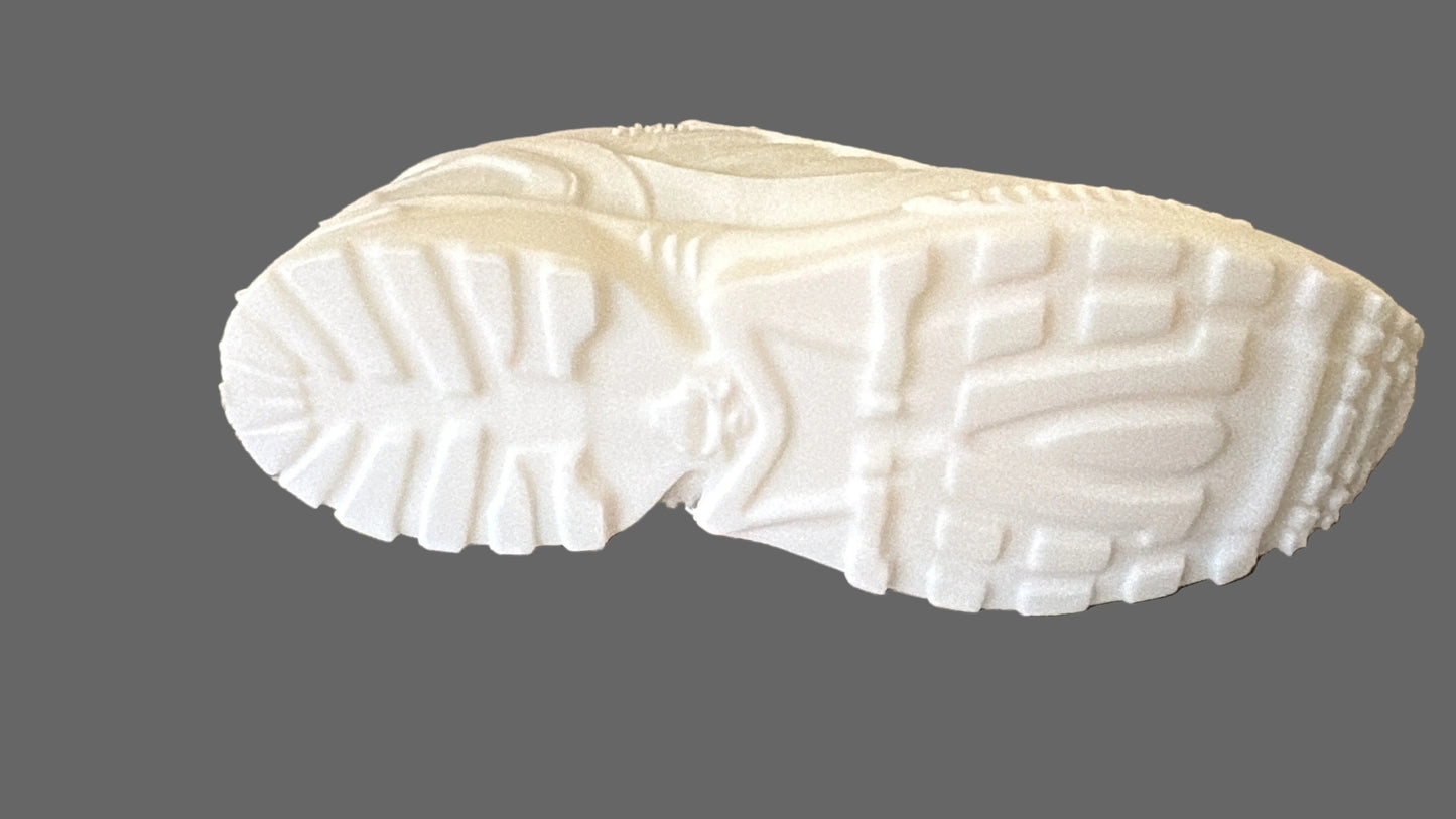 White shoe sole on a textured gray surface