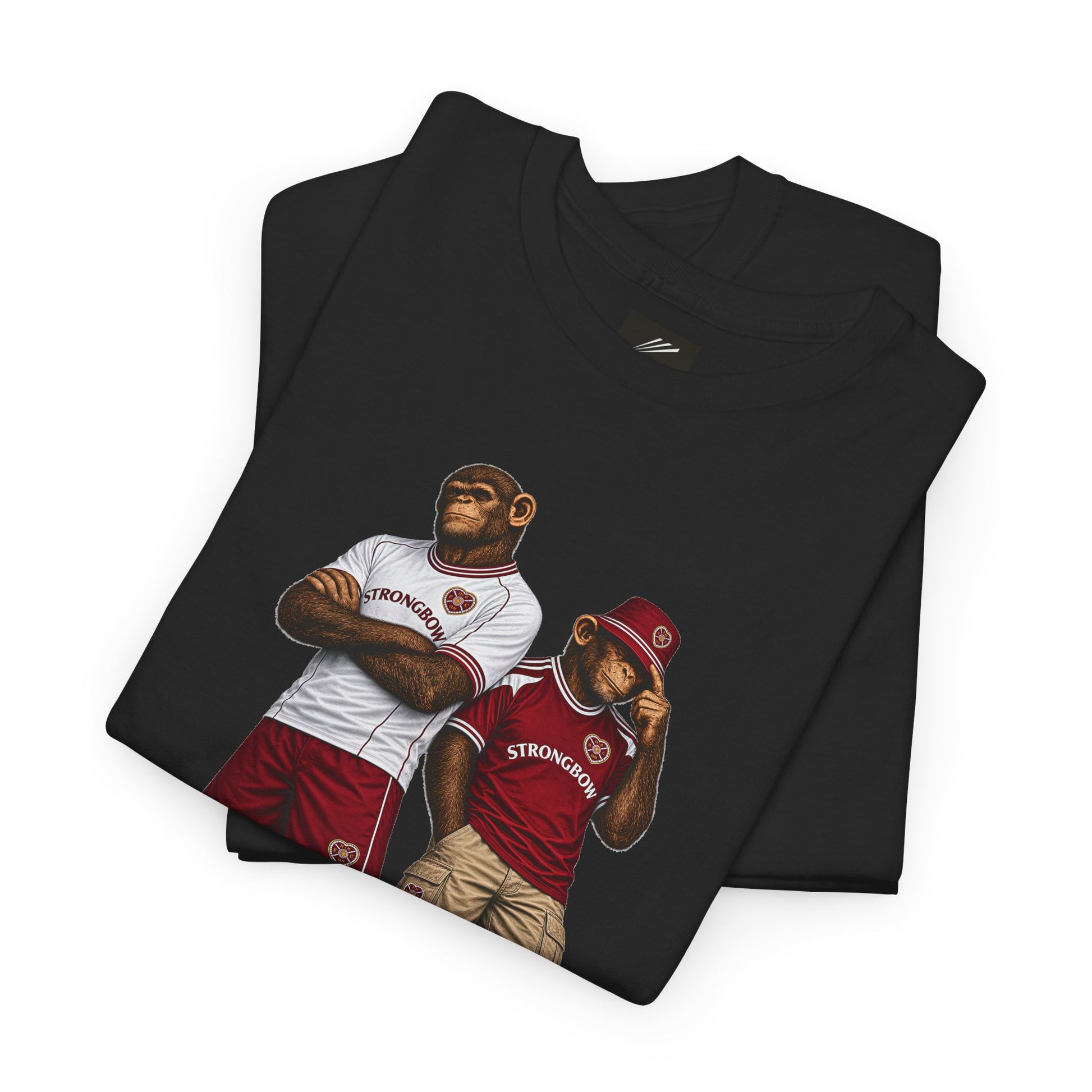 A folded black Hearts t-shirt on a white background, featuring a graphic print of two apes wearing red and white jerseys with the word 'STRONGMAN' on the front.
