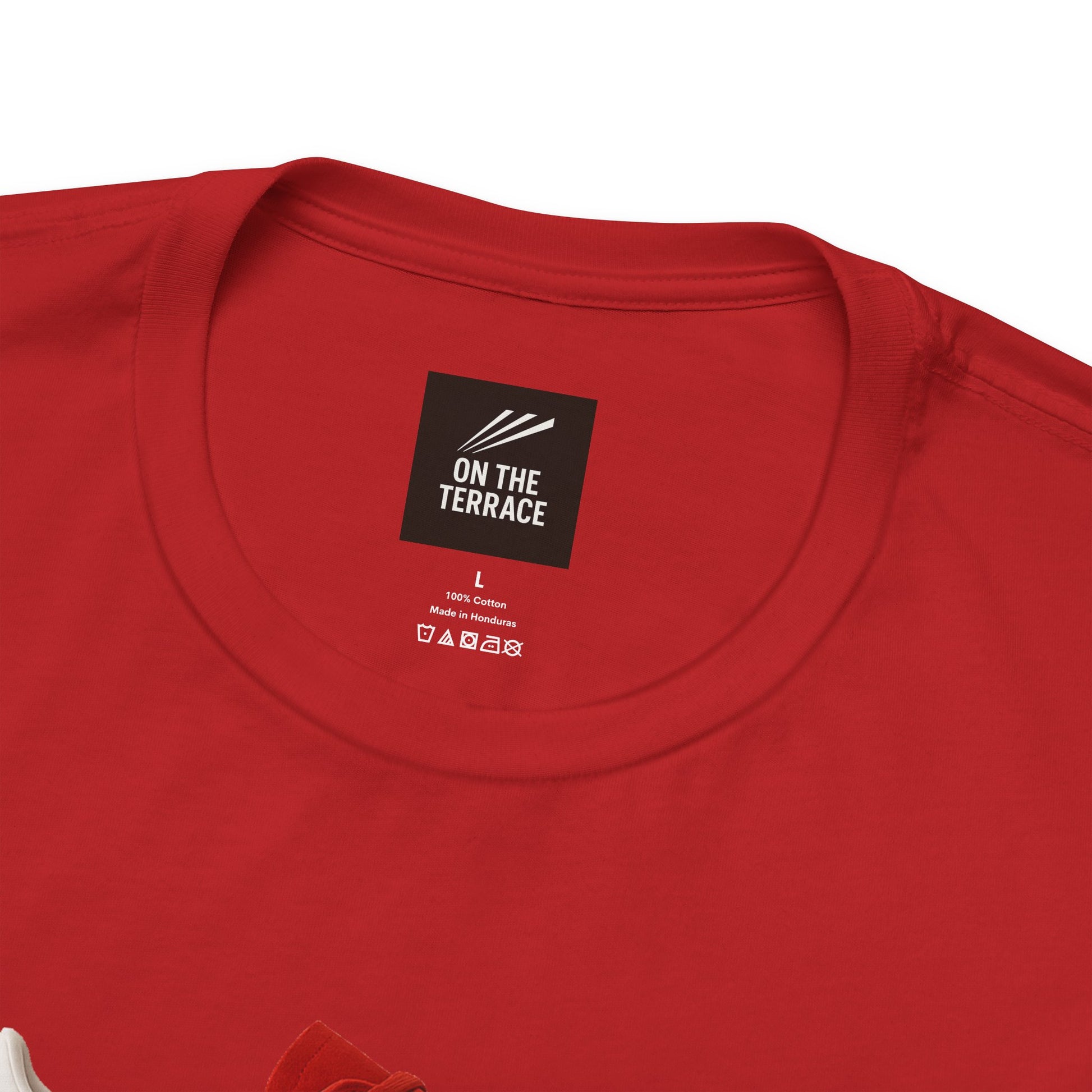 Close-up of red cotton T-shirt neckline with On The Terrace brand label and care instructions