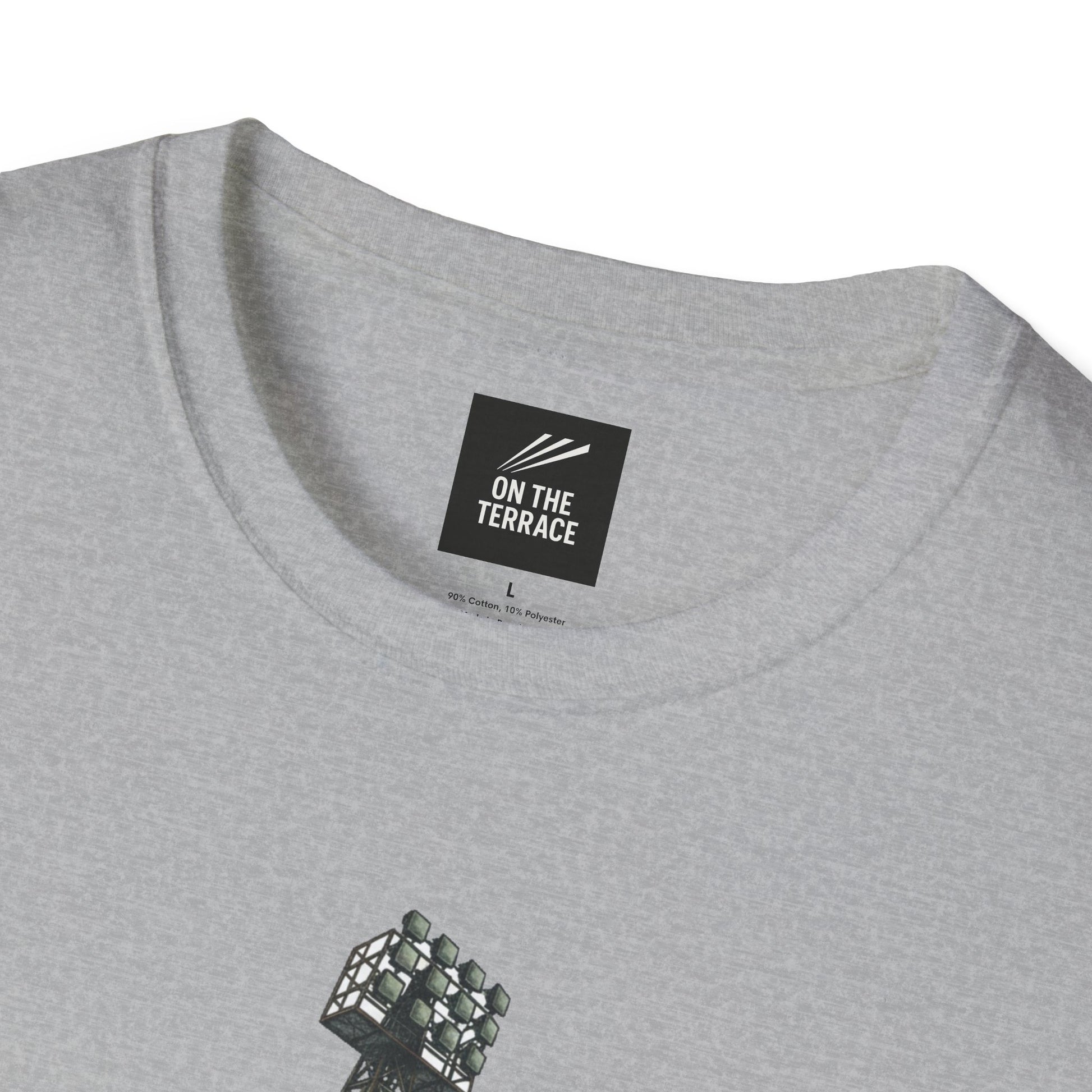 Close-up of gray t-shirt collar with On The Terrace brand label and part of stadium floodlights print