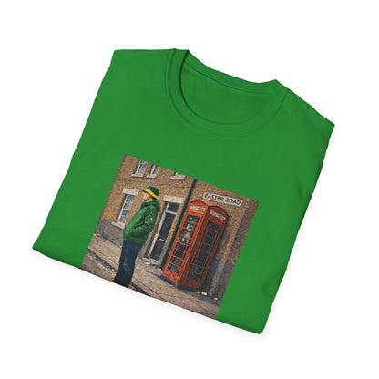 Green t-shirt with a printed design of a person in a green jacket and a red telephone box on a white background
