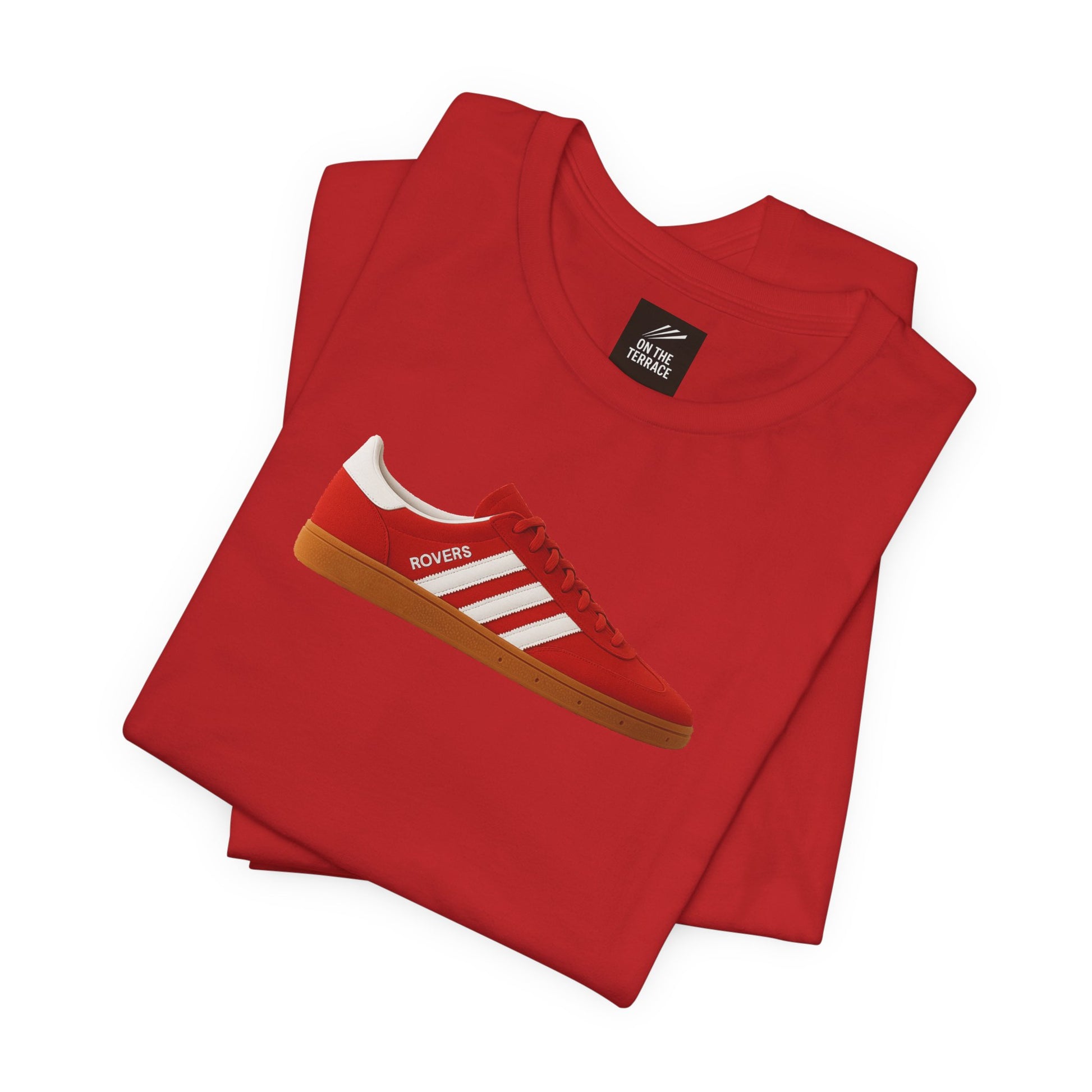 Red folded t-shirt with graphic of red and white Rovers sneaker and On The Terrace label