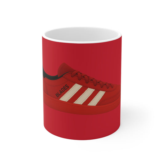 Red ceramic mug featuring illustration of a red sneaker with white stripes and word Blades