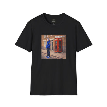 Black t-shirt with a printed design of a person standing next to a red telephone box on a white background