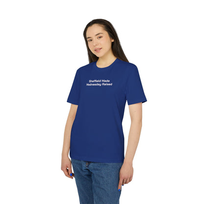 Woman in jeans wearing the royal blue Sheffield Made Wednesday Raised embroidered tee
