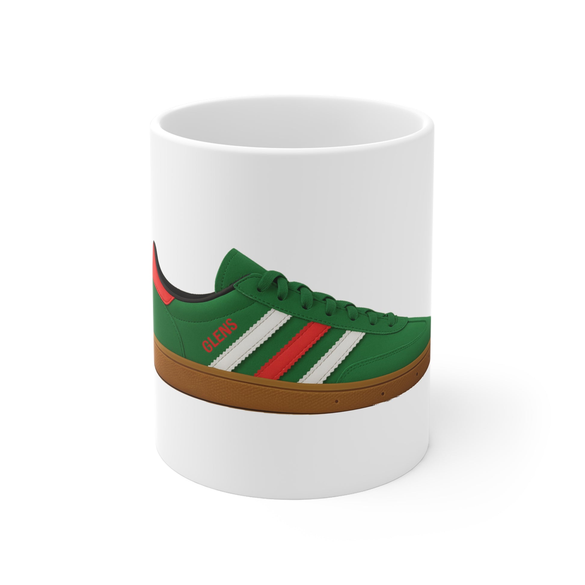 White ceramic mug featuring a green sneaker design with red and white stripes and brown sole