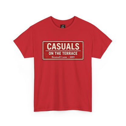 A red short-sleeve SUFC t-shirt featuring a distressed vintage-style street sign graphic on the chest that reads 'CASUALS ON THE TERRACE Bramall Lane - 1889'.