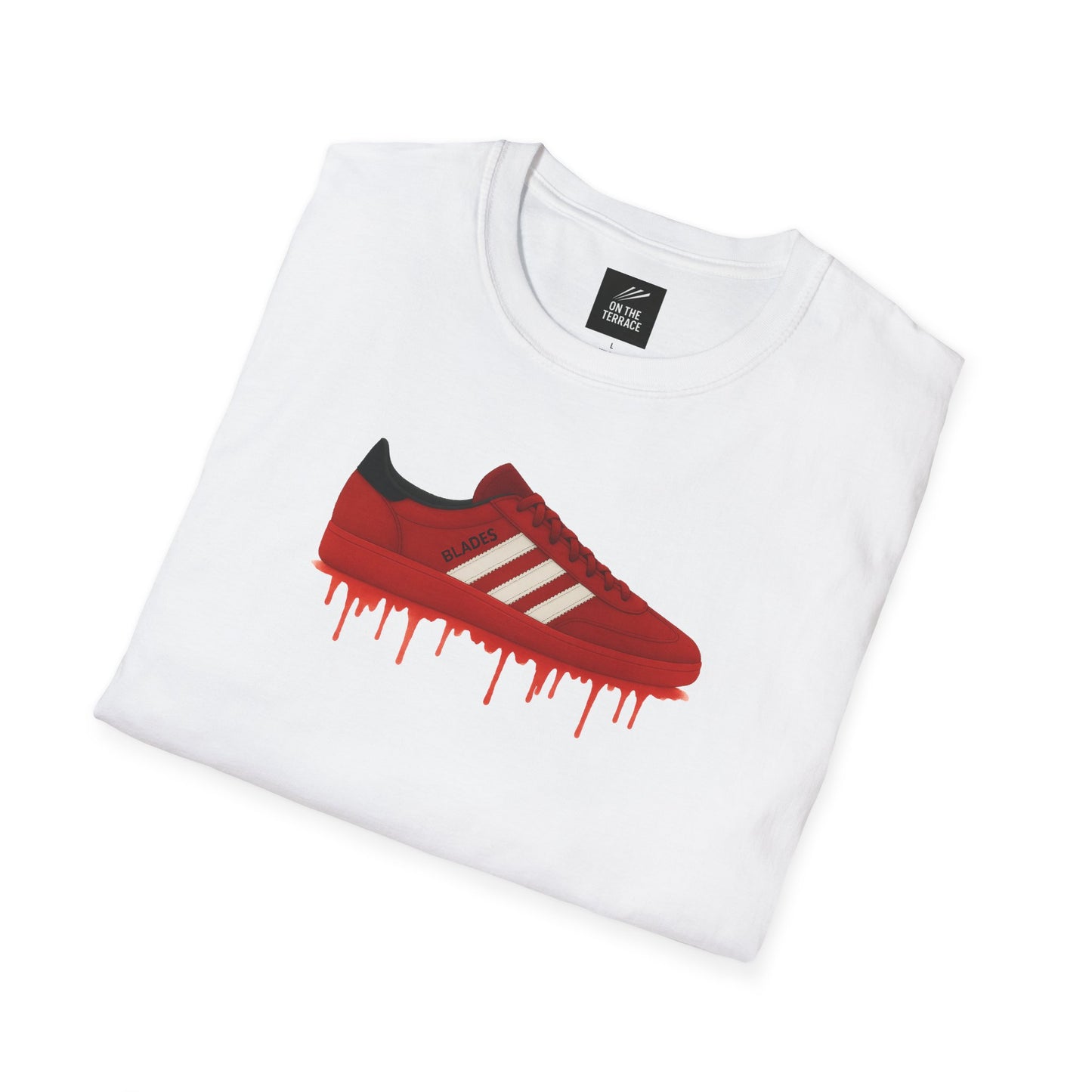 White folded T-shirt with a red sneaker graphic featuring white stripes and dripping paint design