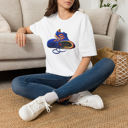 Girl in a White t-shirt with illustration of blue and orange adidas Gazelle-style trainers, terrace casual sneaker graphic tee, vintage trainer collection, On The Terrace