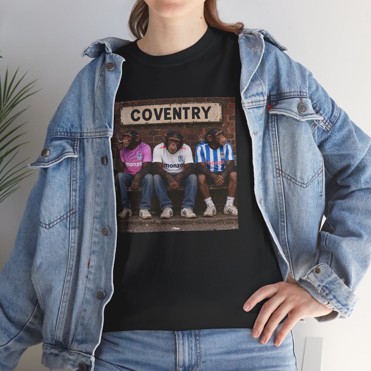 Woman wearing the black Coventry Monkeys T-shirt under a denim jacket