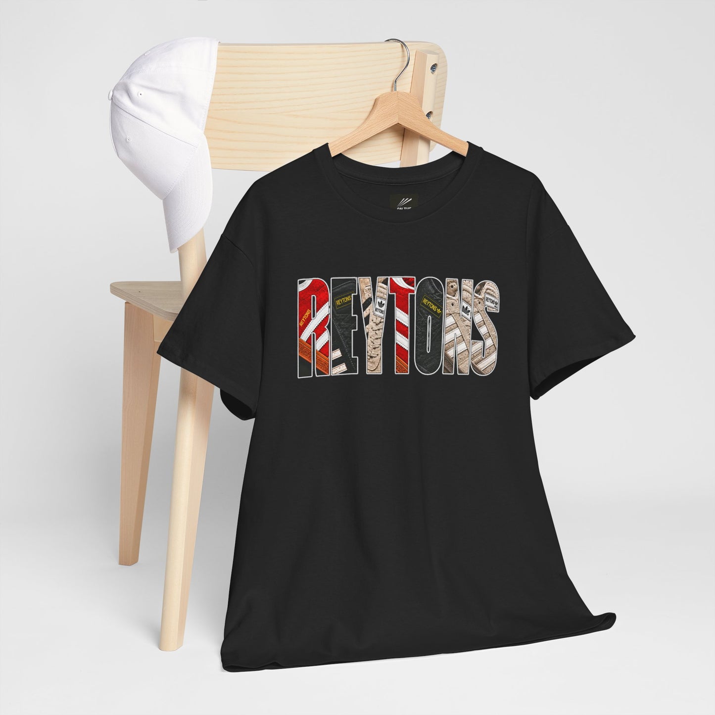Black Reytons t-shirt with 'Reytons ?' text on a hanger against a white background