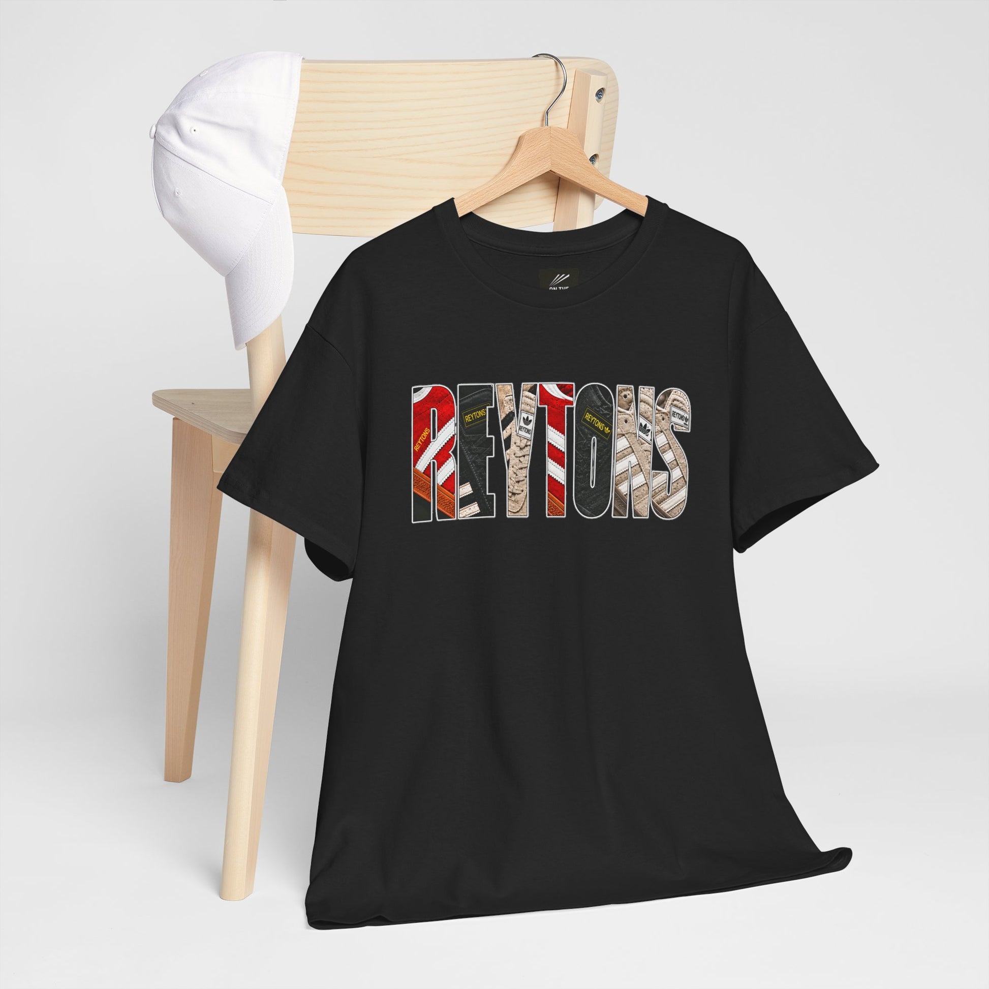 Black Reytons t-shirt with 'Reytons ?' text on a hanger against a white background