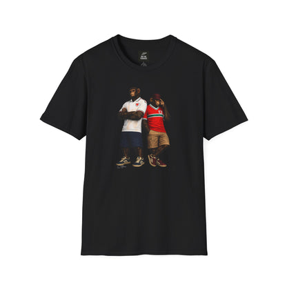 A black short-sleeved t-shirt featuring a central graphic of two chimpanzees styled as Wales national football team supporters. The chimpanzee on the left stands with arms crossed, wearing a white away jersey with green and red trim on the collar and a red dragon crest. The chimpanzee on the right wears the classic red Wales home jersey featuring a prominent green and white horizontal chest stripe, paired with khaki cargo shorts and a burgundy bucket hat
