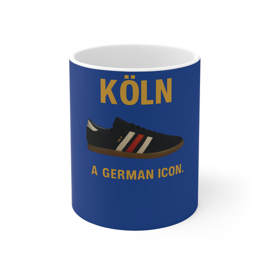 Blue mug featuring a black sneaker with white and red stripes and gold text Köln a German icon