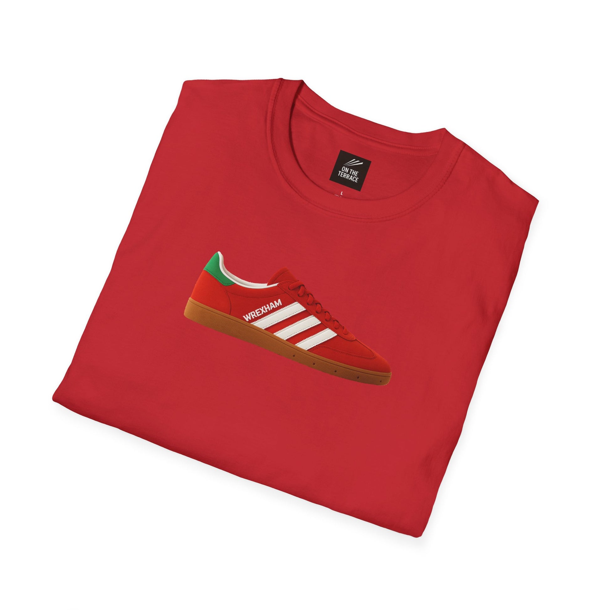 Red folded t-shirt featuring a red sneaker graphic with white stripes and green heel detail, labeled Wrexham