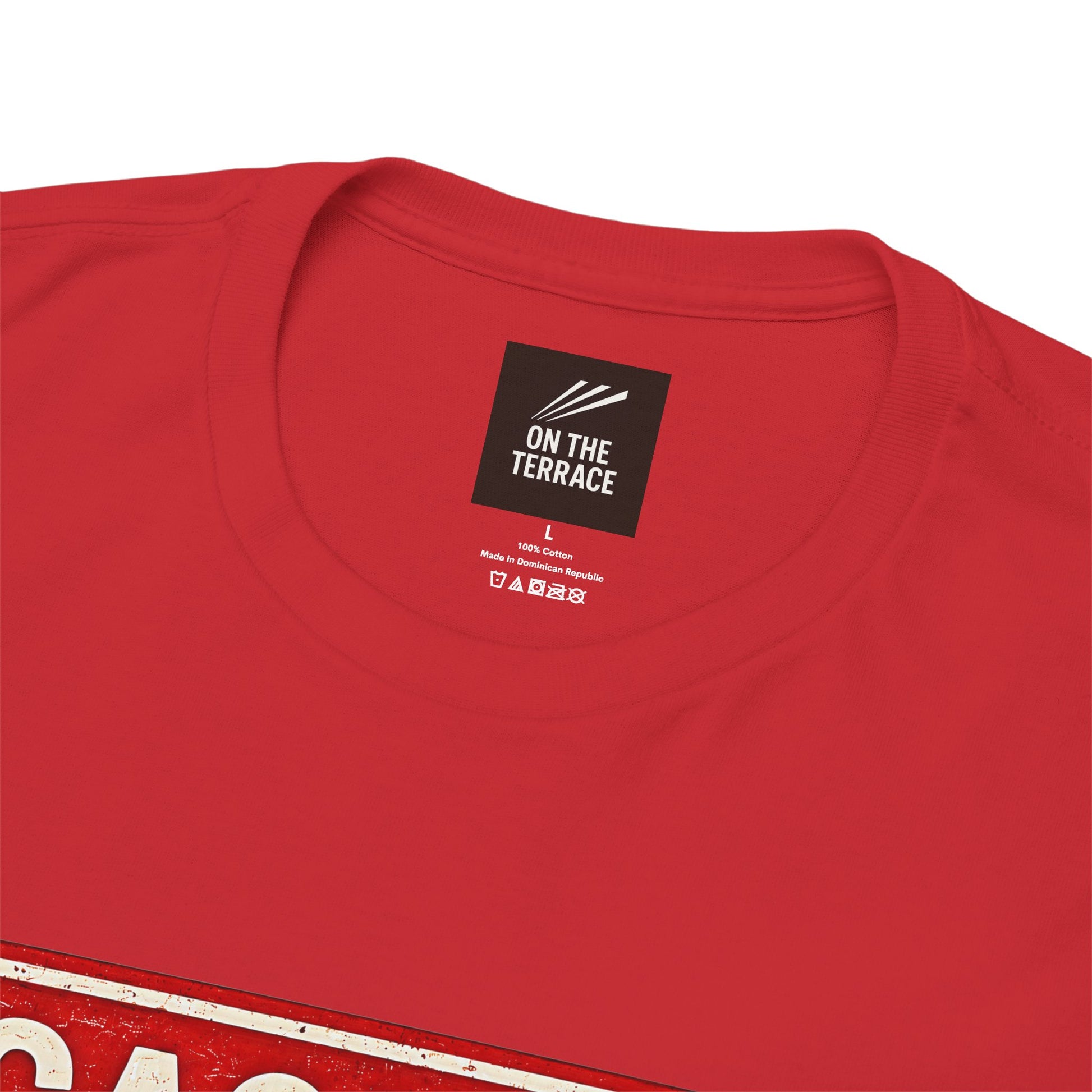 Close-up of a red short-sleeve Rotherham t-shirt showing the inner neck label which reads 'ON THE TERRACE' on a white background.