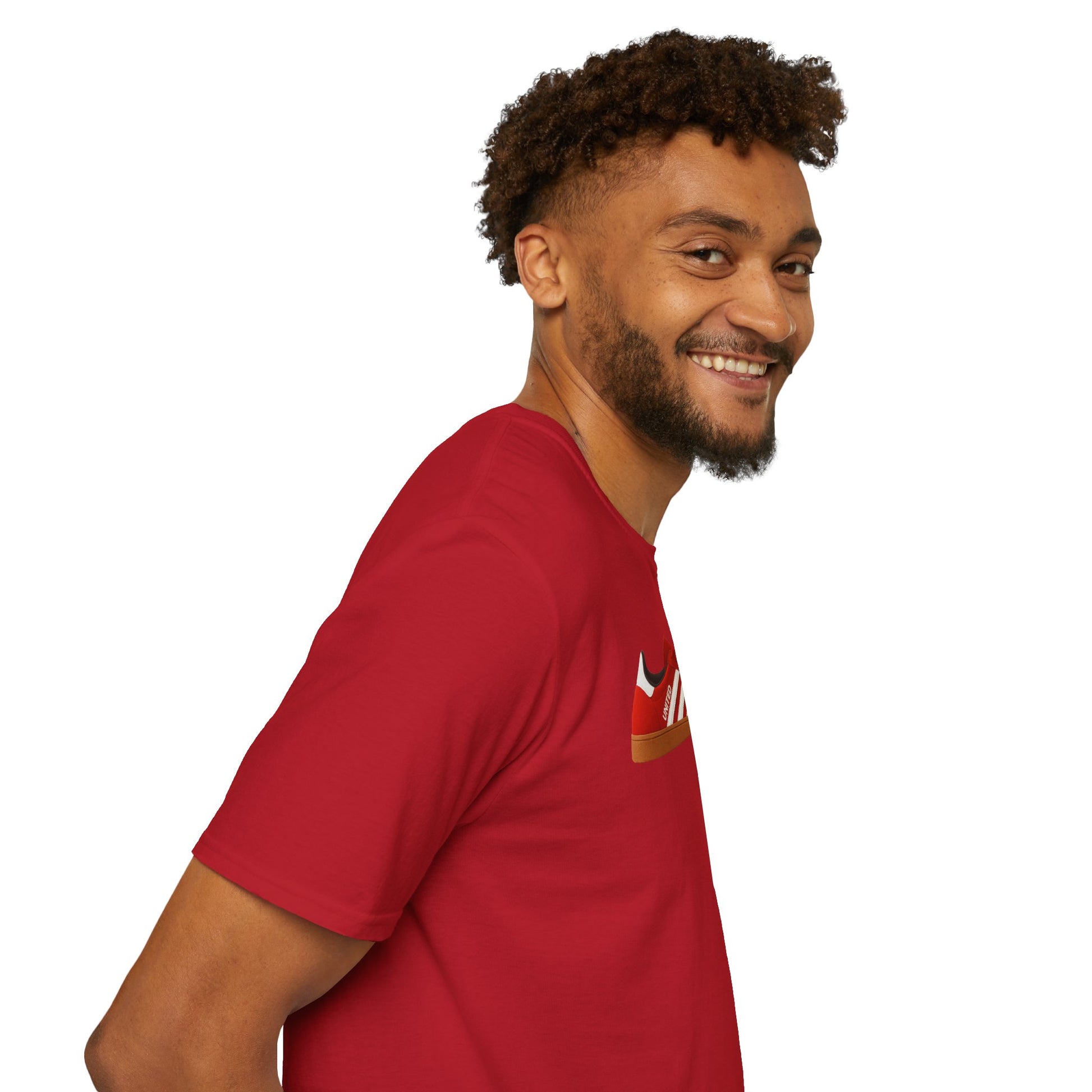 Smiling man with curly hair wearing a red t-shirt with a sneaker graphic on white background
