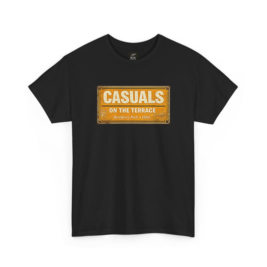 A black short-sleeve HULL CITY t-shirt with a vintage-style orange and yellow rectangular graphic on the chest that reads 'CASUALS ON THE TERRACE'