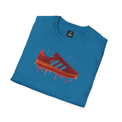 Blue t-shirt with graphic of red sneaker featuring blue stripes and artistic paint drip effect
