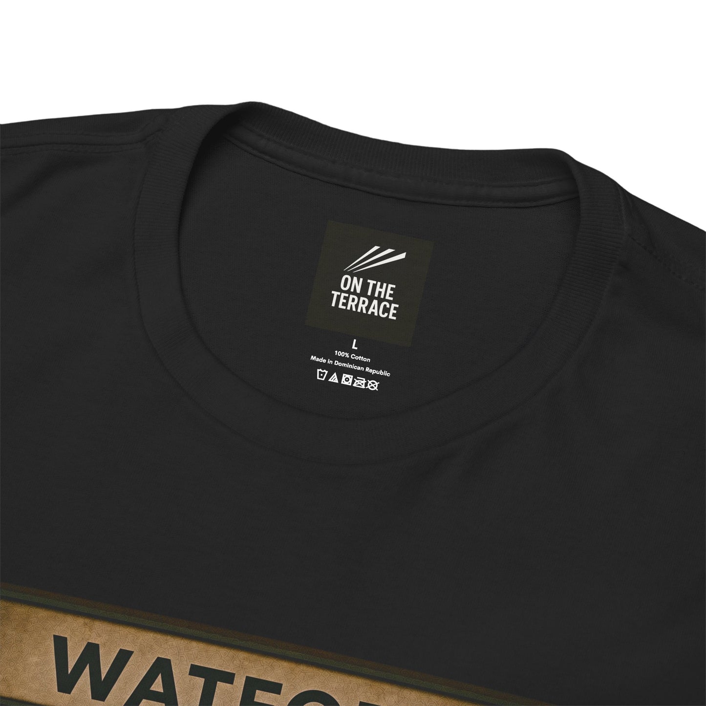 A black heavy cotton t-shirt flat lay from the file Front 2 (20).png, showing a square graphic print of three chimpanzees dressed as football casuals in retro trainers and a yellow, red, and black Watford scarf, sitting on a station bench under a Watford sign.