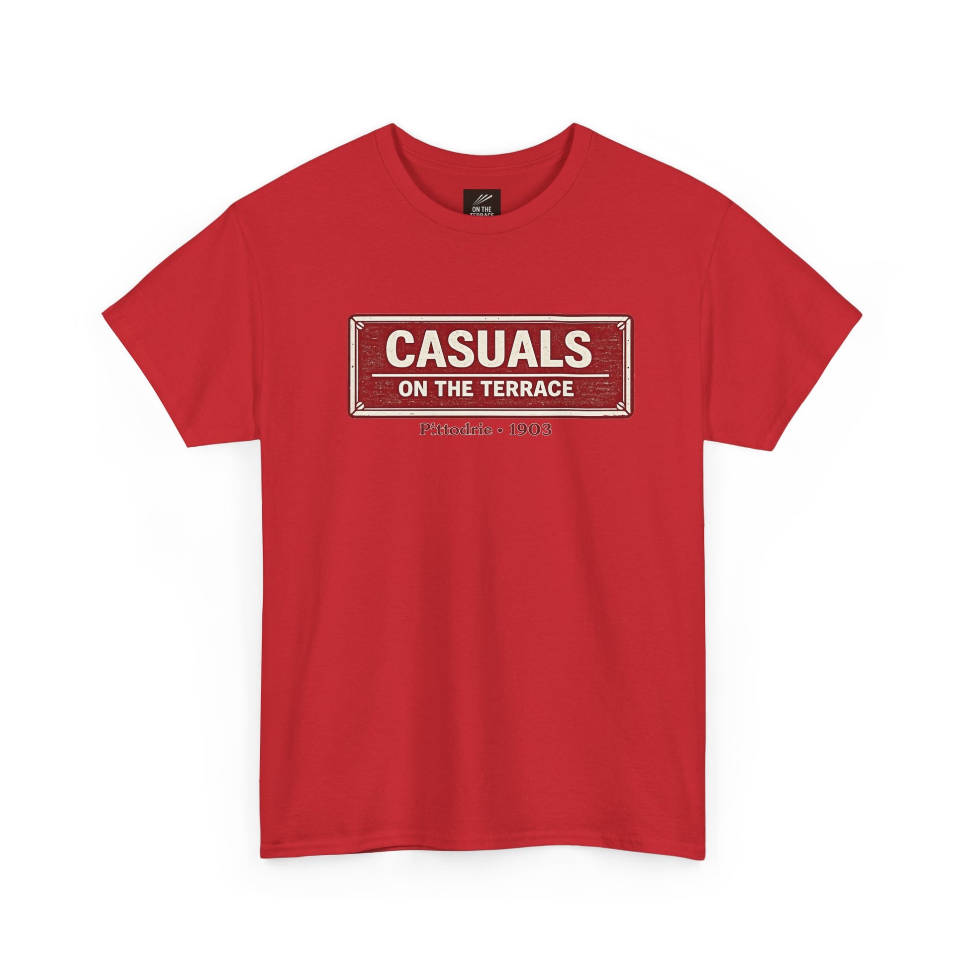 A red heavy cotton Aberdeen t-shirt flat lay featuring a central vintage red and white street sign graphic reading "CASUALS ON THE TERRACE" with "Pittodrie • 1903" printed below, and an inner neck label for On The Terrace., displayed on a clean white background.