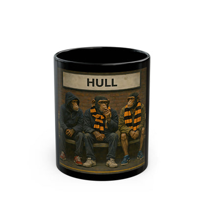 Black mug with illustrations of three chimpanzees wearing scarves and sitting on a bench, with 'HULL' text above them.