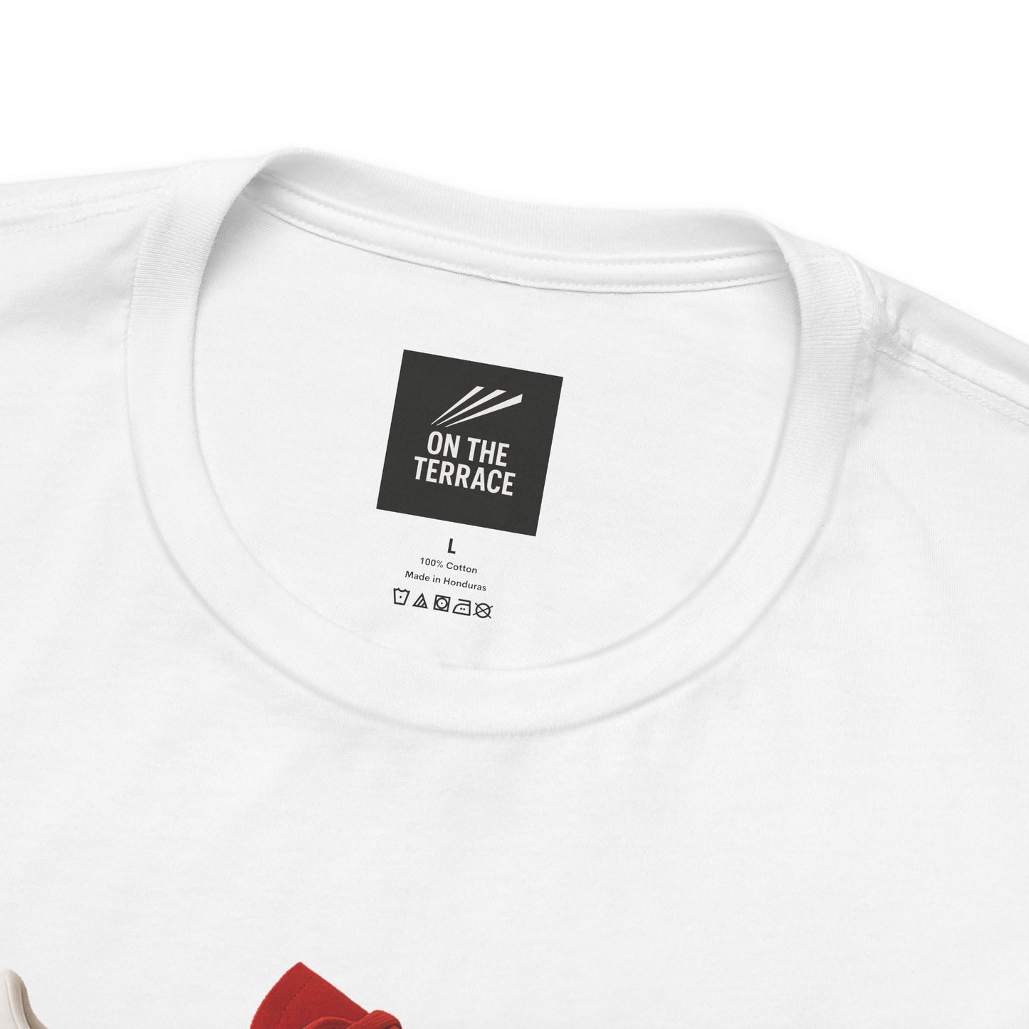 Close-up of white cotton T-shirt neckline with On The Terrace brand label and washing instructions