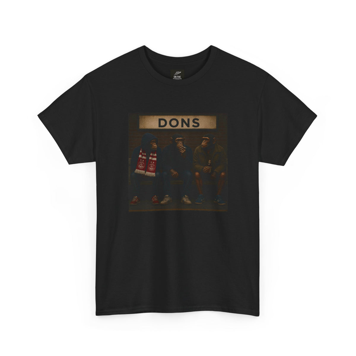 A black short-sleeve crewneck Aberdeen t-shirt featuring a rectangular graphic print on the front with the word 'DONS' above a dark-toned illustration of four men standing together.
