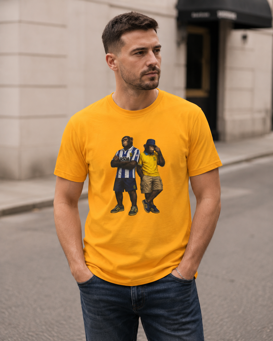 A man wearing a bright yellow swfc t-shirt with a graphic print of two men, standing on a city street.