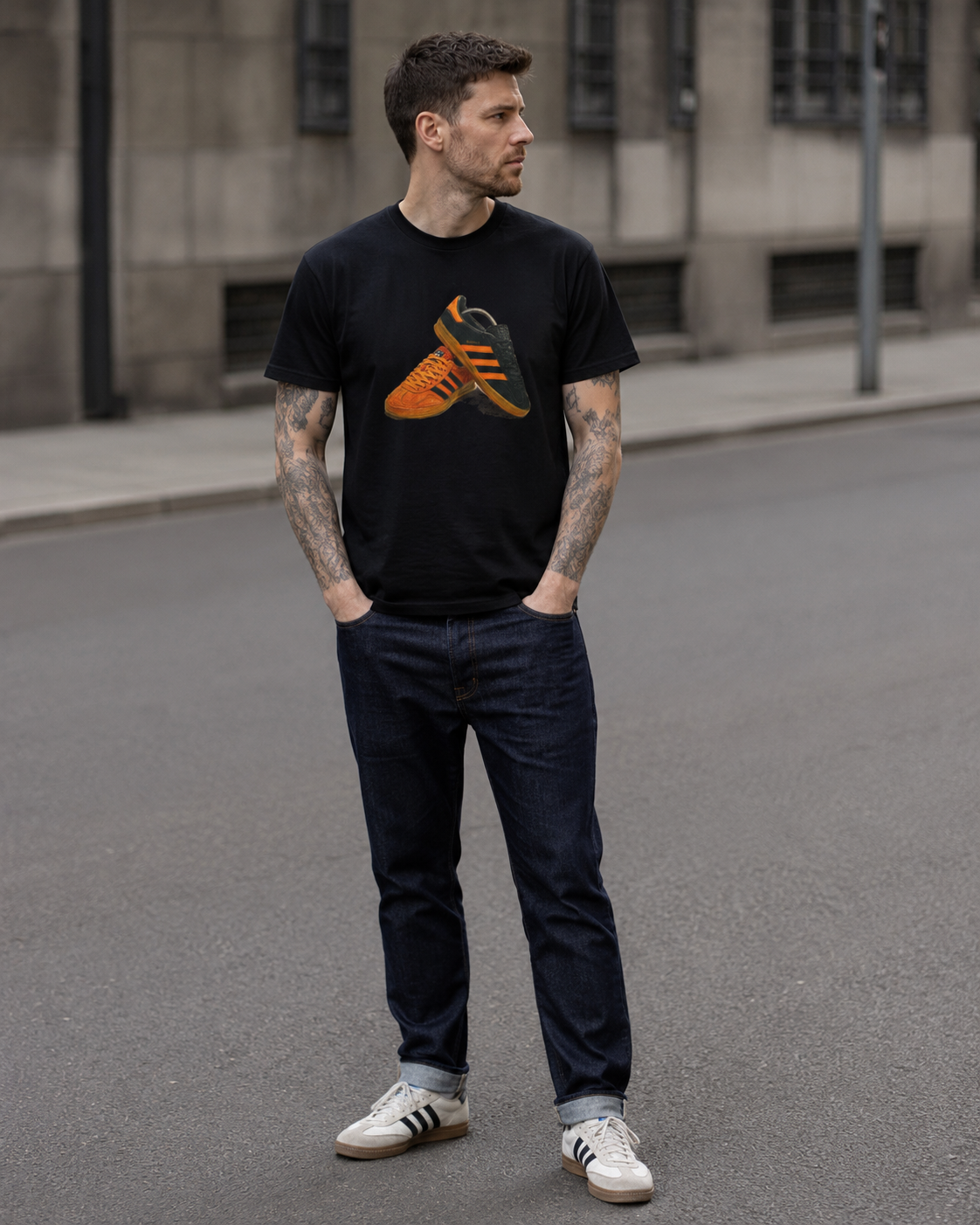 Man wearing the black tee with an orange and gold retro sneaker graphic