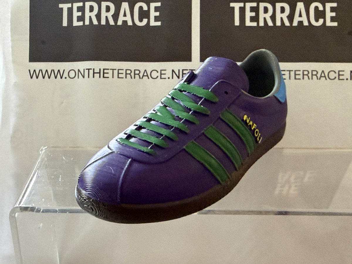 adidas Napoli inspired 3D printed trainer model, purple with green stripes and laces, on a clear display stand