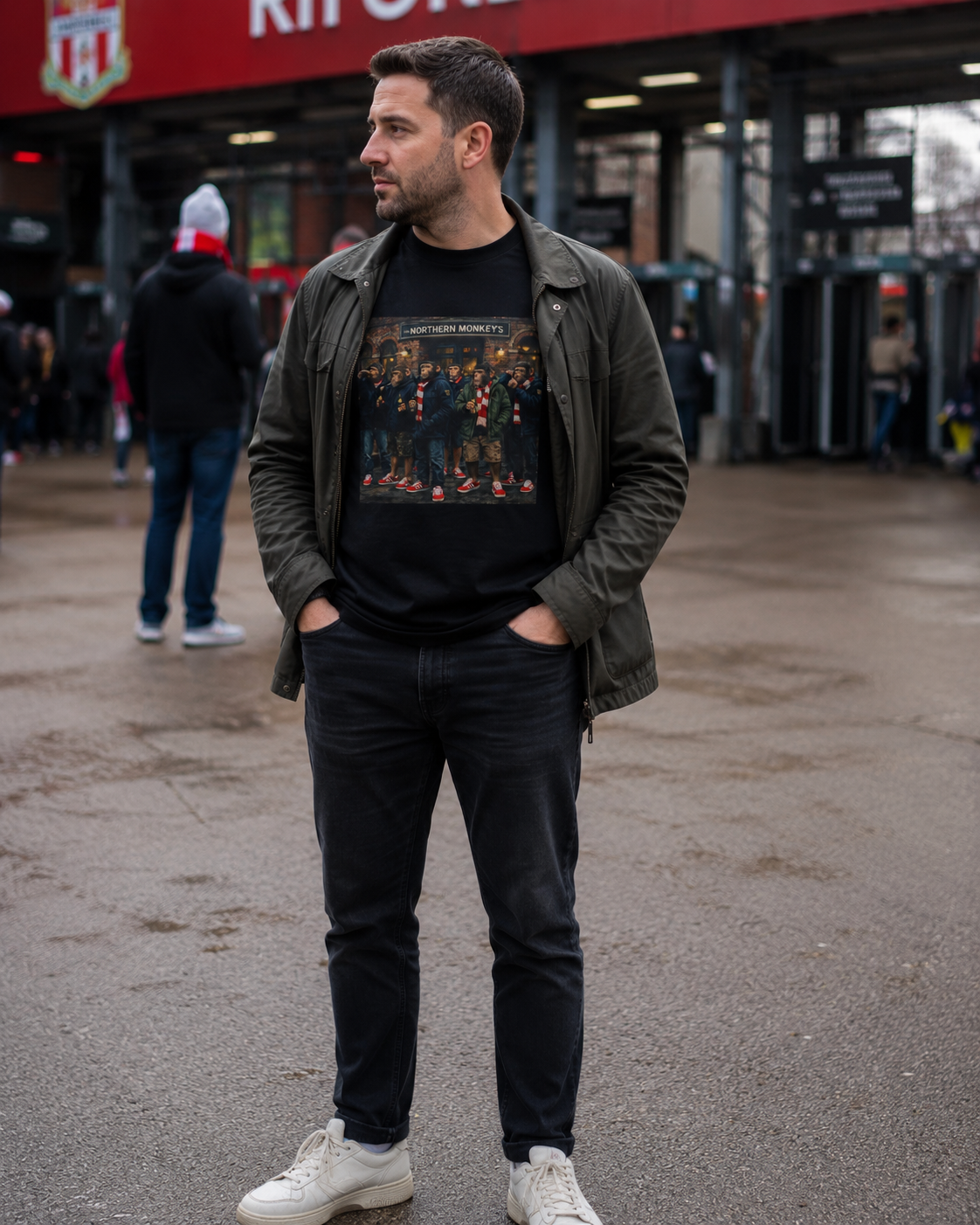 Man wearing the Northern Monkeys 'Red and Whites' tee - chimps outside a brick pub
